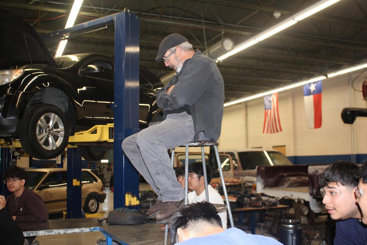 Automotive teacher observing from above.