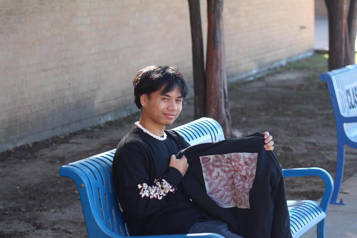 Ti Ilon displays his designs.
